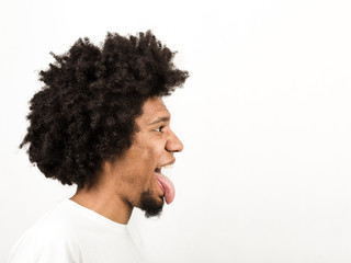 Emotional facial expression of man - showing tongue