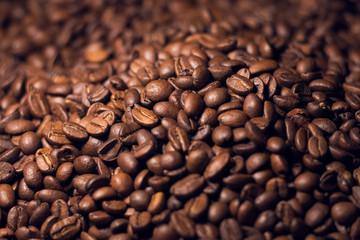 Blurred heap of coffee beans with narrow focus