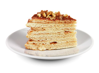 Piece of cake with nuts and chocolate crumbs on white plate