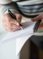  Closeup of Businessman writing in notepad