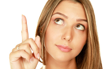 Portrait of a young woman pointing up