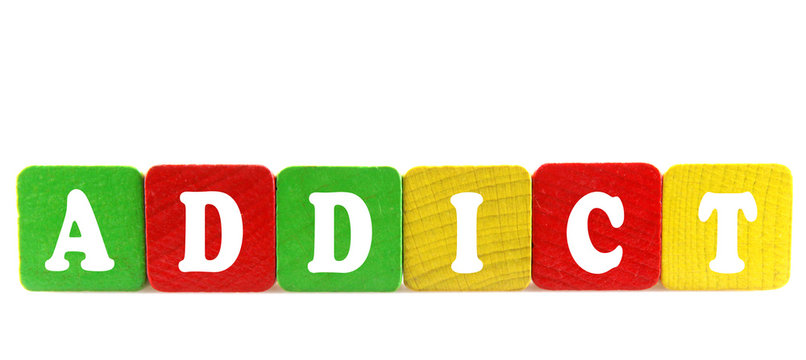 addict - isolated text in wooden building blocks