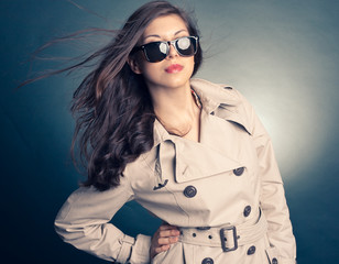 beautiful woman in the raincoat and sunglasses