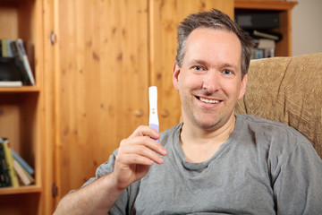 Man holding a pregnancy test