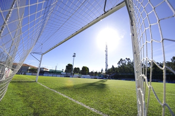Naklejka premium football or soccer goal and blue sky in the stadium