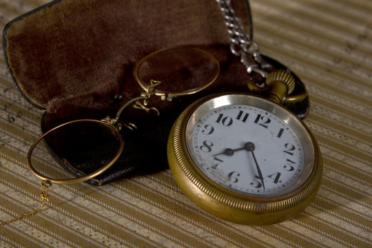 Pocket watch and glasses