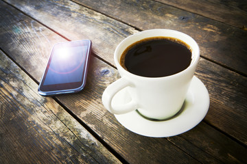 Fototapeta na wymiar Cup of coffee and a smartphone.