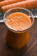 carrot juice on a wooden background