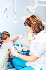 Dentist showing toy teeth