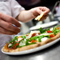 Closeup hand of chef baker in white uniform making pizza at kitc - 50700282