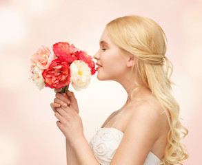 woman smelling bouquet of flowers