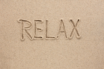 The word relax written on the sand