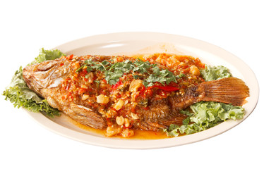 fried fish with fresh herbs and  sweet spicy sauce  on plate