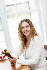 Smiling woman with smart phone