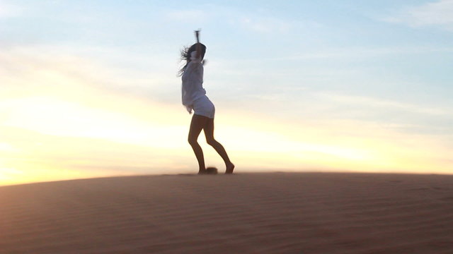 Beautiful woman dancing in desert