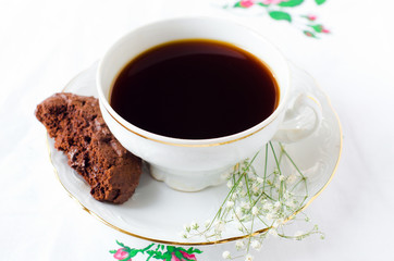 A Cup of coffee with chocolate biscuits