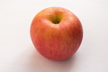 A red apple on a white background.