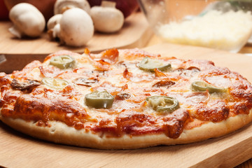 Pizza with cheese, ham and jalapeno pepper