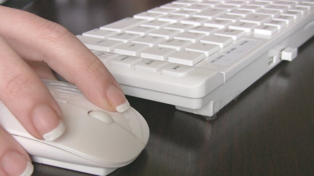 Close up of a hand typing on keyboard.