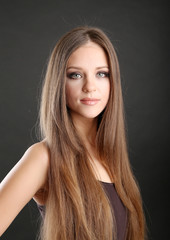 Portrait of beautiful woman with long hair on black background