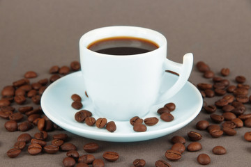 Cup of strong coffee on grey background