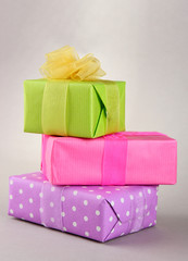 Bright gifts with bows on grey background