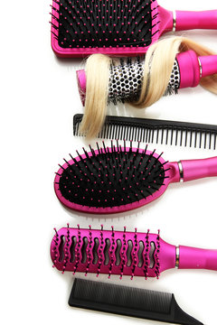Comb brushes with hair, isolated on white