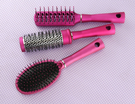 Comb brushes on purple background