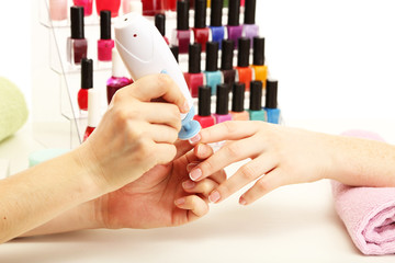 Manicure process in beauty salon, close up