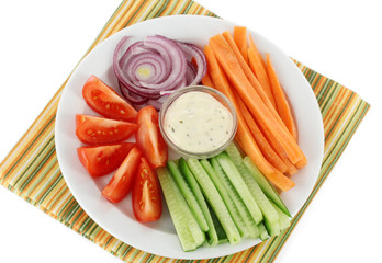 Assorted raw vegetables sticks in plate close up