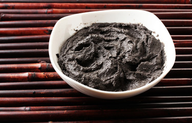 Cosmetic clay for spa treatments, on bamboo background