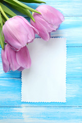Beautiful bouquet of purple tulips and blank card