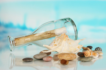 Original glass bottle with letter on sea background