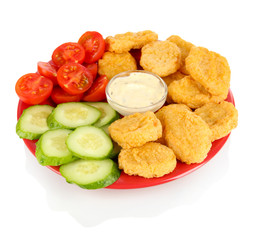Fried chicken nuggets with vegetables and sauce isolated