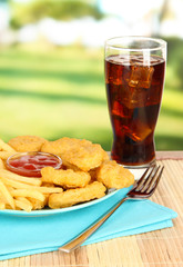 Fried chicken nuggets with french fries,cola and sauce