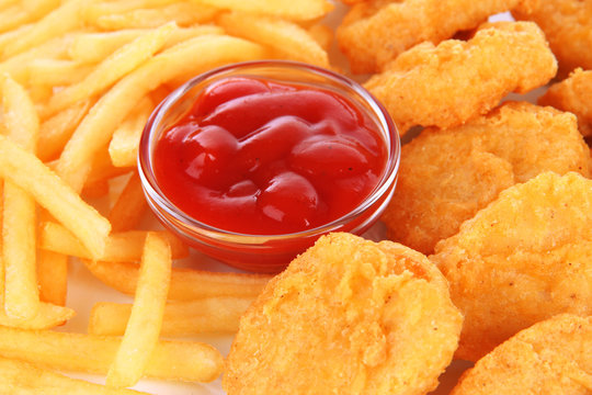 Fried chicken nuggets with french fries and sauce isolated