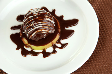 Small portion of food on big plate on brown napkin