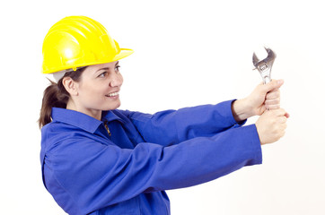 Female builder with helmet and big wrench