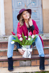 smiling beautiful glamour woman in hat outdoor with flowers