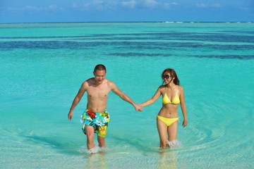 happy young  couple enjoying summer on beach