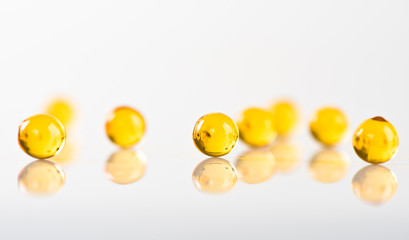 yellow capsules isolated on white