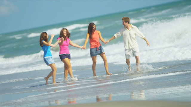 Carefree Caucasian Family Enjoying Beach Vacation