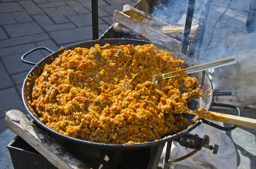 cooking asian pilaf plov in big metal pan