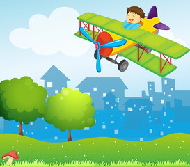 A boy riding in a plane above the hill