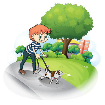A boy walking with his dog along the street