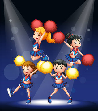 A cheering squad with red and yellow pompoms