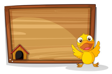 A baby duck in front of a wooden board