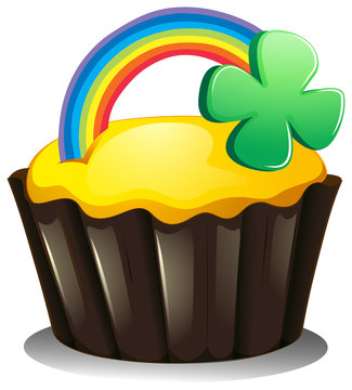 A cupcake with a rainbow and a plant