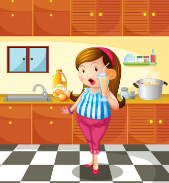 A lady holding an orange juice inside the kitchen