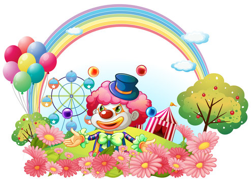 A clown in the garden with a carnival at the back